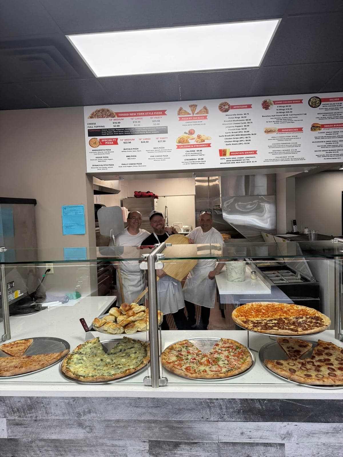 The Ray's Pizzeria family behind the counter in Kenosha